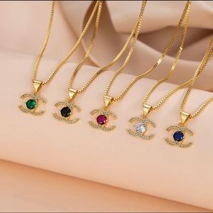 Gold Charm Necklace brand new. Colors Red, Blue, White, Black, and Emerald.